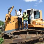 ceo eng samuel oruma poses with a plant operator during pipe laying program in 2021 at iliminaliki